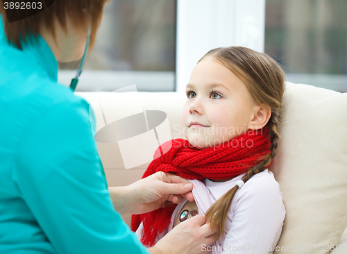 Image of Doctor is examining little girl using stethoscope