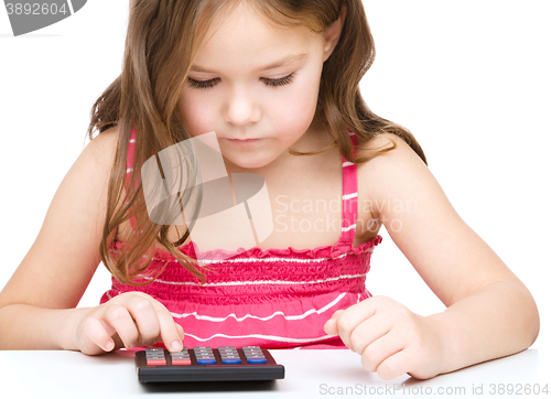 Image of Little girl is using calculator