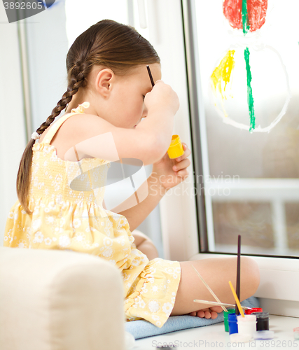 Image of Portrait of a cute girl playing with paints