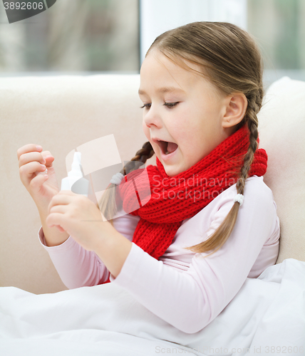 Image of Little girl spraying her nose