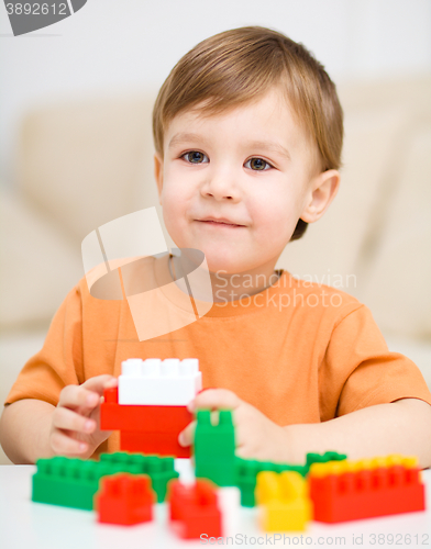 Image of Boy is playing with building blocks