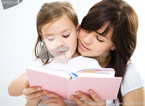 Image of Mother is reading book with her daughter