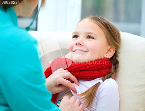 Image of Doctor is examining little girl using stethoscope