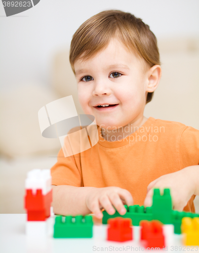 Image of Boy is playing with building blocks