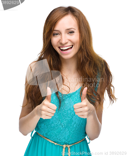 Image of Woman is showing thumb up gesture