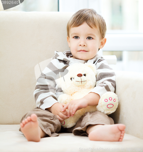 Image of Portrait of a little boy with his teddy bear
