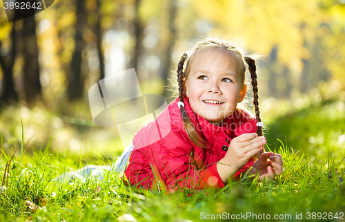 Image of Portrait of a little girl in autumn park