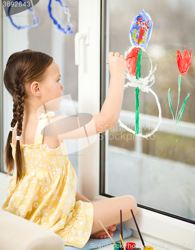 Image of Portrait of a cute girl playing with paints