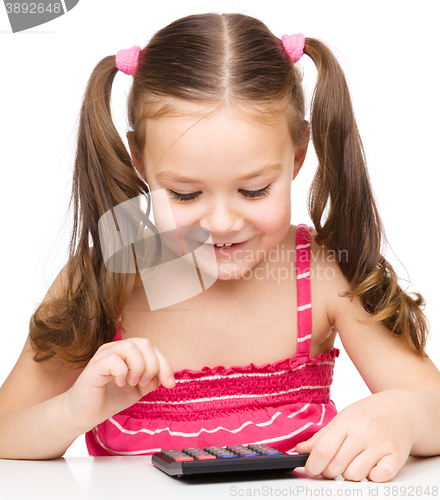 Image of Little girl is using calculator