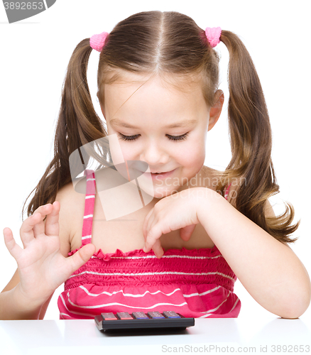 Image of Little girl is using calculator