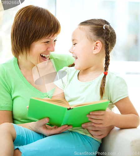Image of Mother is reading book with her daughter