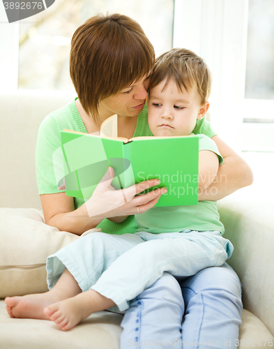 Image of Mother is reading book for her son