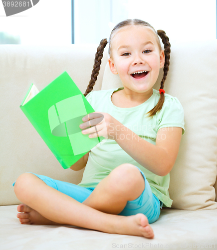 Image of Little girl reads a book