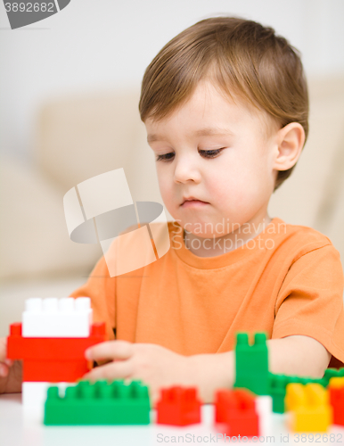 Image of Boy is playing with building blocks