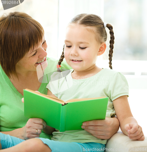 Image of Mother is reading book for her daughter