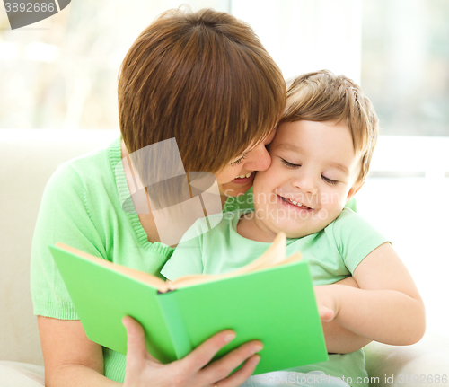 Image of Mother is reading book for her son