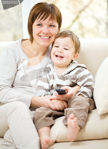 Image of Mother and her son are watching tv