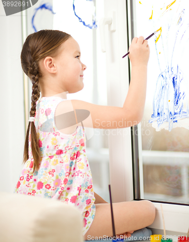 Image of Portrait of a cute girl playing with paints