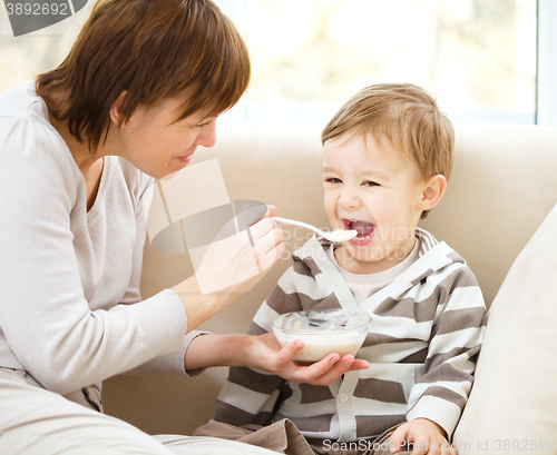 Image of Mother is feeding her son