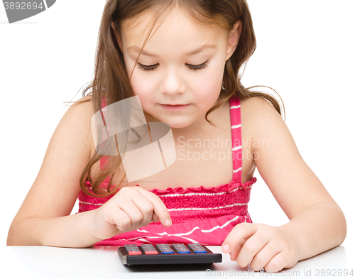 Image of Little girl is using calculator