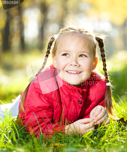 Image of Portrait of a little girl in autumn park