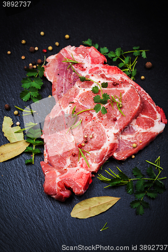 Image of Fresh raw pork meat on black board