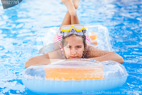Image of Cute girl relaxing in pool