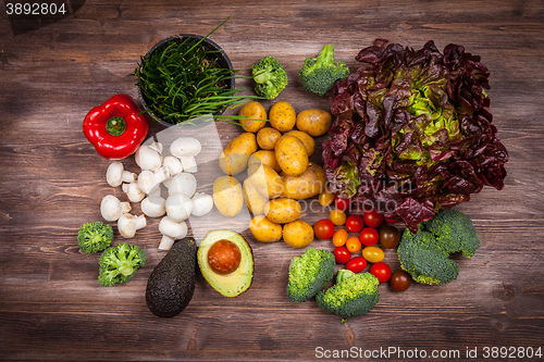 Image of Assorted raw vegetables on wooden background