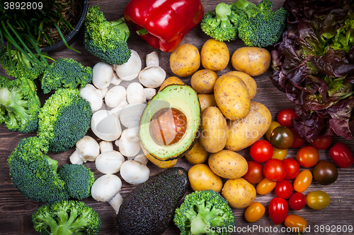 Image of Assorted raw vegetables on wooden background