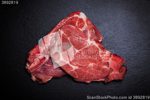 Image of Fresh raw meat on black board