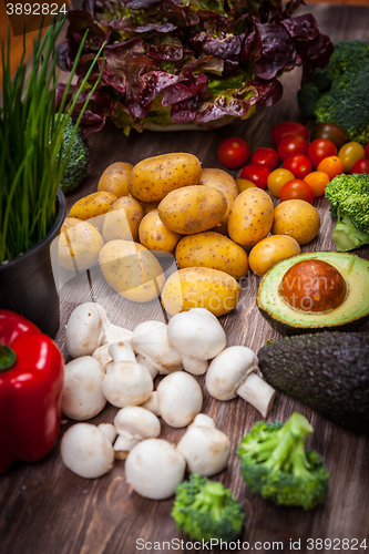 Image of Assorted raw vegetables on wooden background