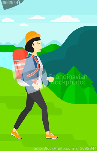 Image of Woman with backpack hiking.