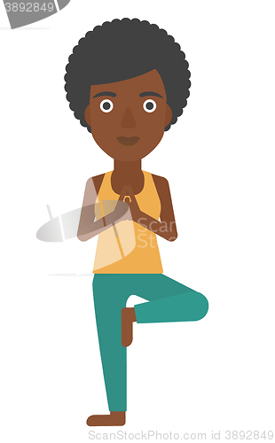 Image of Woman practicing yoga.