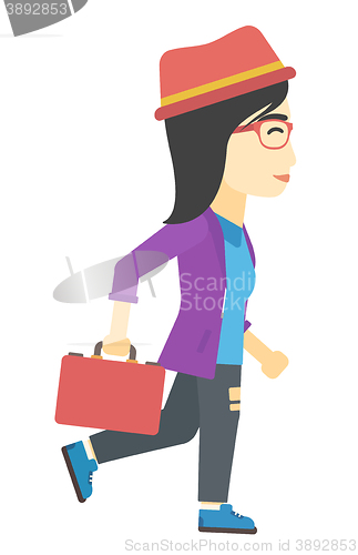 Image of Business woman walking with briefcase.
