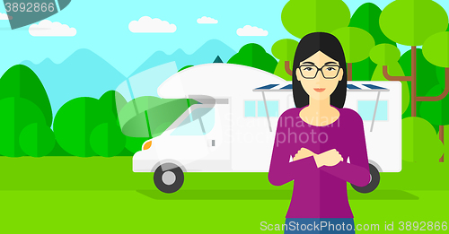 Image of Woman standing in front of motor home.