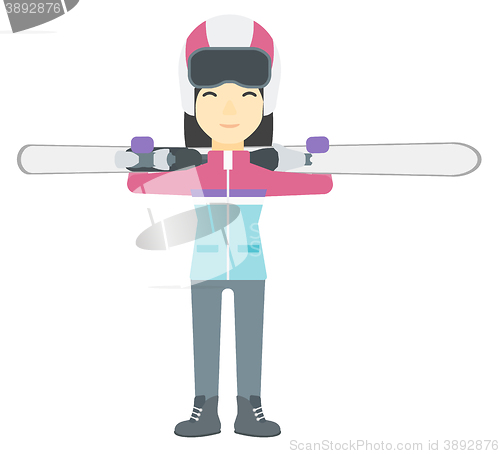 Image of Woman holding skis.