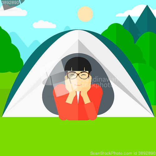 Image of Man lying in tent.