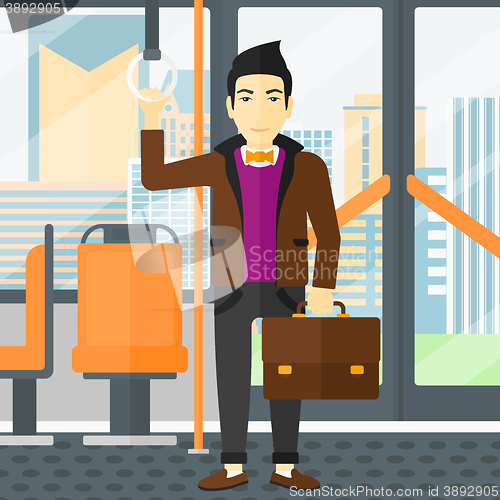 Image of Man standing inside public transport.