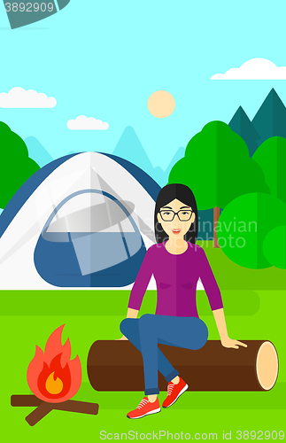 Image of Woman sitting at camp.