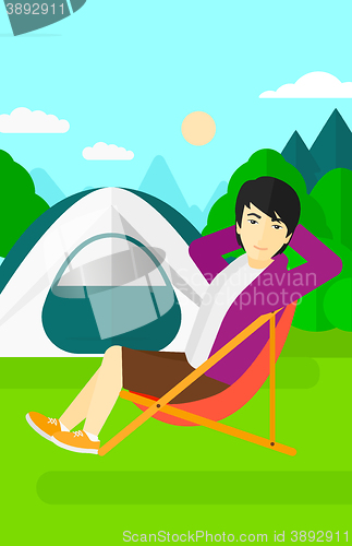 Image of Man sitting in folding chair.