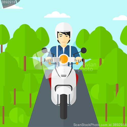 Image of Man riding scooter.