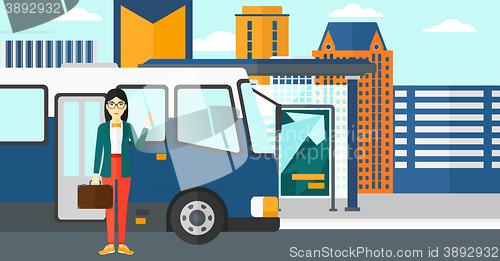 Image of Woman standing near bus.