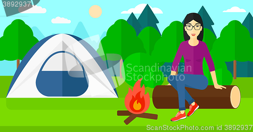 Image of Woman sitting at camp.
