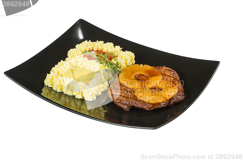 Image of Pork tenderloin with grilled pineapple. Macro. Isolated white background