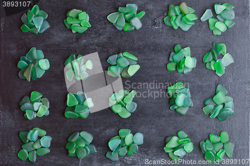 Image of small green pieces of glass polished by the sea