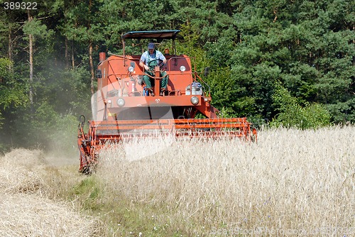 Image of red combine harvester