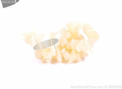 Image of Splintered orange calcite chain on white background