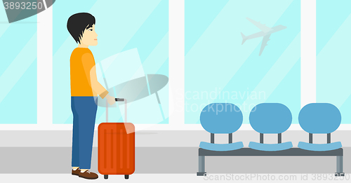 Image of Man at airport with suitcase.