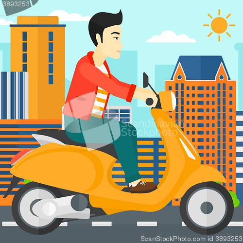 Image of Man riding scooter.