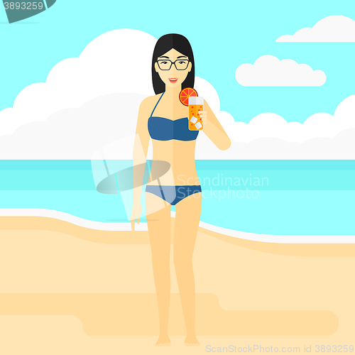 Image of Tourist with cocktail on the beach.